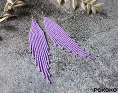 These light purple beaded earrings pair amazingly with any outfit, dressy or casual. They will emphasize your individuality and compliment your personality on various occasions. Perfect for looking pulled together and on trend. They are made of high-quality Czech colored beads with sterling silver hooks and silicone plugs. Colors: light purple. Length: 4.5 inches (11.5 cm) Width: 1 inches (2.5 cm) Materials:     Czech "Preciosa" beads     Durable synthetic thread     Sterling silver ear hooks Purple Beaded Earrings, Chandelier Luxury, Beadwork Earrings, Long Earring, Purple Beaded, Luxury Earrings, Earrings Long, Seed Bead Earrings, Ear Hook