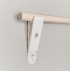 a close up of a white handle on a wall with a stick attached to it