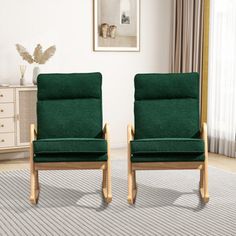 two green chairs sitting next to each other on a rug