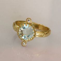 Aquamarine Solitaire Ring. Gemstone of breath, Confidence, clarity and Love. * Pristine Brazilian Rose Cut Aquamarine * 18k Solid Gold * 2 VS SI 0.01ct Natural Brilliant Ethically sourced Diamonds * Sizing included from 4us to 7.5us *Free worldwide Shipping Custom orders Welcomed! For more rings: https://www.etsy.com/shop/templejewelsibiza/items?section_id=21449468 To my shop: https://www.etsy.com/shop/templejewelsibiza 14k Gold Engraved Ring With Bezel Setting For Wedding, Sapphire Rings Stamped 14k, Timeless Yellow Gold Ring With Blue Topaz, Fine Jewelry Yellow Gold Topaz Ring With Diamond Accents, Elegant 14k Stamped Cluster Ring For Promise, 14k Gold Topaz Ring With Rose Cut Diamonds, 14k Yellow Gold Topaz Ring With Rose Cut Diamonds, Sapphire Ring With Diamond Accents In 14k Gold, Aquamarine Diamond Ring For Promise