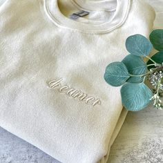 Cream Cotton Sweatshirt With Embroidered Logo, Cream Cotton Sweatshirt With Letter Embroidery, Cream Cotton Sweater With Embroidered Logo, Cream Crew Neck Sweatshirt With Letter Embroidery, Cream Cotton Sweatshirt With Embroidered Text, Cream Sweatshirt With Embroidered Logo Relaxed Fit, Embroidered Cream Long Sleeve Sweatshirt, Cotton Loungewear Sweater With Embroidered Text, Cream Embroidered Long Sleeve Sweatshirt