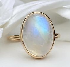 14k Gold Moonstone Ring/Engagement Ring/Rainbow Moonstone/June Birthstone/Three Stone Ring/Diamond Moonstone Band/Valentines Day Gift Women ★ ★ ★ CUSTOM/DUTY FREE SHIPPING WORLDWIDE, BUYERS DON'T HAVE TO PAY ANY CUSTOM FEES WHILE IMPORTING ★ ★ ★ ★ Details ★ Made to order Material: 14k/18k gold Color Options: Yellow Gold, White Gold, Rose Gold, ★ Center Stone Rainbow Moonstone Oval Cabochon Size: 14 x 10 mm Approximate Weight (Ct): 0.92 ★ Accent Stones Diamond/Moissanite Round Size: 1.5 mm * 2 No.s Approximate Weight (Ct): 0.02 ★ Band Width: 1.3 mm ★ Ring Size: 7.5mm ★ 100% Natural Diamond and Gemstones ★ Diamond: Round Brilliant cut, G-H Color, SI Clarity ☂ Shipped with Insured Shipping with 4-7 business days. ➦ 100% Free Returns. ➦ Our Jewelry comes with Lifetime Warranty. (Stone replacem Band Valentines, Gold Moonstone Ring, Moonstone Engagement Ring, Three Stone Ring, June Birthstone, Three Stone Rings, Ring Diamond, Moonstone Ring, Ring Engagement