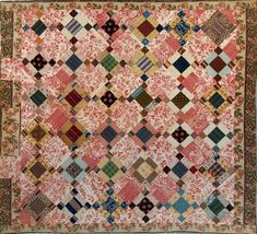 an old quilt with many different colors and patterns