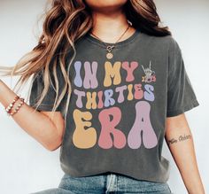 Celebrate the fabulous thirties era with our In My Thirties Era t-shirt - the perfect gift for a 30th birthday! This fun and trendy design captures the essence of being in your thirties, making it a thoughtful and fun gift for anyone entering this exciting era of life. Make this milestone birthday even more special with our In My Thirties Era t-shirt! DETAILS * Comfort Colors Garment-Dyed Heavyweight T-Shirt * 100% ring spun cotton * Design is printed using DTG technology which uses high-quality water-based inks that are printed directly into the fabric. This means that there may be a slightly faded/vintage look to the design depending on the color and fabric of the garment. SIZING * These unisex T-shirts are true-to-size with a relaxed fit. * Most women find their typical size works best 30th Birthday Tshirt, In My 30s, My 30s, Funny Birthday Shirts, 30th Birthday Shirts, 40th Birthday Shirts, Groovy Retro, Birthday Party Shirt, 30th Birthday Gifts