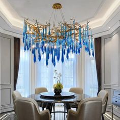 a chandelier hanging from the ceiling in a dining room