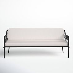 a white couch sitting on top of a wooden frame