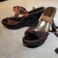 Beautiful Wedge Sandals By Rouge. Size 6 Strap Across The Top Of The Foot With Knot Detail. 30" Ribbon Ties Around Ankle. 4" Wedge Heel Is Wrapped In Black "Lace" Fabric. Excellent Condition. Brown Wedge Sandals For Party, Brown Wedge Heel Sandals For Party, Casual Brown Wedge Sandals For Party, Elegant Brown Wedge Sandals For Summer, Elegant Brown Summer Wedge Sandals, Slip-on Wedge Sandals With Red Sole, Brown Open Toe Wedge Sandals With 4-inch Heel, Adjustable Brown Slip-on Wedge Sandals, Black Lace Fabric