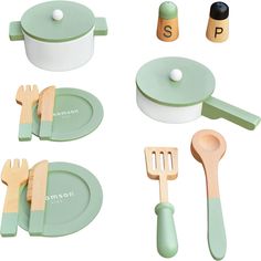 various wooden utensils and spoons are arranged on a white surface with letters