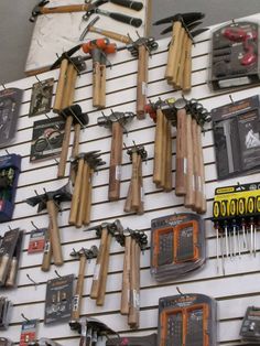 there are many tools hanging on the wall