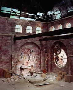 an old building with several windows and clocks on the wall, in front of a table