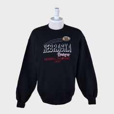 Embroidered Vintage 1997 National Champions Nebraska Cornhuskers (University of Nebraska-Lincoln) Football/Basketball NCAA Sweatshirt 💯 SATISFACTION AND AUTHENTICITY ⭐ MEASUREMENTS (when laid flat) Size on Tag: L Length: 71cm or 28 inches Armpit to armpit: 58cm or 23 inches ⭐ CONDITION 9/10 (Very good) Details: No holes Material: Cotton Color: Black Brand: NAS 🔷 Please give us your phone no. together with address after you purchased. 🔷Please keep in mind that our items are vintage so they may Throwback Long Sleeve T-shirt For College, Throwback College Tops With Embroidered Logo, Cotton Throwback Sweatshirt For Fan Gear, Cotton Throwback Fan Gear Sweatshirt, Throwback Fleece Sweatshirt For College, Throwback Cotton Sweatshirt With Embroidered Logo, Throwback Sweatshirt For Game Day, Throwback Cotton College Sweatshirt, Throwback Fan Gear Hoodie Sweatshirt