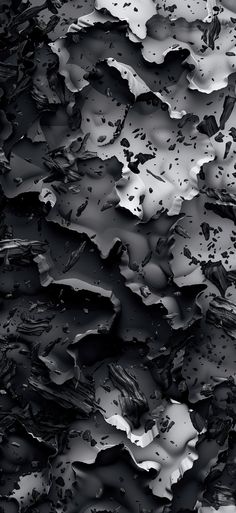 black and white photograph of water droplets on the surface with dark colors that appear to be melted