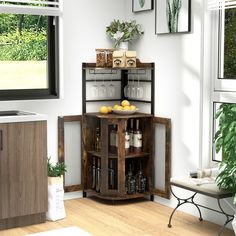 a corner cabinet with wine glasses, lemons and bottles on it in front of a window