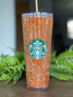 a starbucks cup with sprinkles and a straw