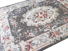 an area rug is shown with flowers and leaves on the carpet, as well as other decorations