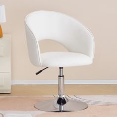 a white chair sitting on top of a carpeted floor next to a lamp and dresser