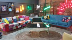 a living room with couches, tables and neon lights on the wall behind them