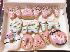 a box filled with lots of decorated doughnuts