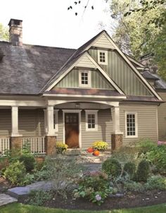 a house that is in the grass with flowers