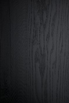 black wood grained surface with dark background