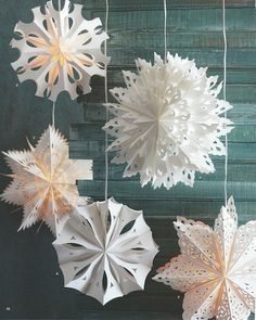 several paper snowflakes hanging from strings