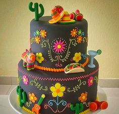 a three tiered cake decorated with flowers and cactus decorations