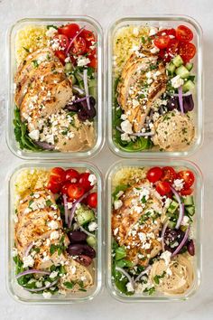 four plastic containers filled with chicken, vegetables and feta cheese on top of each other