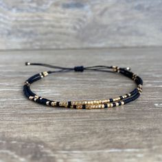 A delicate and elegant string bracelet made of two strands of black and gold miyuki beads. ☆ ☆ ☆ SIZING☆ ☆ ☆ This bracelet is easily adjustable thanks to a macrame slide knot. It should fit most adults and teens but please message me if you think you need a smaller or larger fit. It is about 5 inches when fully tightened and about 9 inches when expanded. ☆ ☆ ☆ TAKING CARE OF YOUR BRACELET ☆ ☆ ☆ This bracelet is NOT waterproof. If you want to retain its original qualities over time, please remove Chip Jewelry, Bracelet Styles, Miyuki Bracelet, Black Beaded Bracelets, Cord Jewelry, Diy Bracelet Designs, Beads Bracelet Design, Minimalist Bracelet, Miyuki Beads