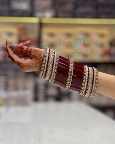 a woman holding out her hand with bracelets on it