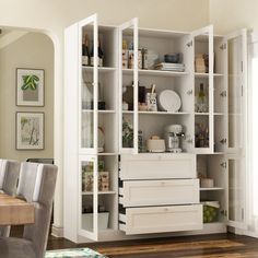 an open bookcase in the middle of a dining room