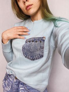 "One of a kind sweatshirt with denim pocket decorated with big silver spikes. Soft and comfortable azure blue cotton sweatshirt with a twist - customized by hand. Shorter than typical pullover, please check measurements below. Material: cotton Size: Small Bust: 96 cm / 38\" Bottom width: 96 cm / 38\" Length: 54 cm / 21 1/4\" Sleeve: 66 cm / 26\" More tops from my shop: https://www.etsy.com/shop/sisudenimstore/?section_id=21387151 Sisu Denim is a part of Sisu Vintage Store, which you can find her Trendy Blue Sweatshirt With Pockets, Blue Sweatshirt With Side Pockets For Fall, Light Blue Streetwear Tops With Pockets, Blue Long Sleeve Sweatshirt With Side Pockets, Blue Distressed Crew Neck Sweatshirt, Acid Wash Sweatshirt With Pockets Relaxed Fit, Acid Wash Cotton Sweatshirt With Pockets, Blue Distressed Cotton Sweatshirt, Long Sleeve Light Wash Top For Streetwear