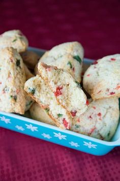 some cookies are in a blue dish on a red tablecloth and there is no image here to provide a caption for