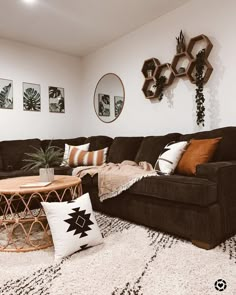 a living room filled with lots of furniture and decor on top of a white rug