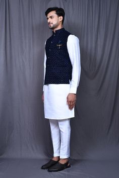 Navy blue satin silk nehru jacket with thread and sequins embroidery. Comes with white pant and a kurta.
Components: 3
Pattern: Embroidered
Type Of Work: Thread, Sequins
Neckline: Nehru Jacket : Mandarin collar, Kurta : Band collar
Sleeve Type: Nehru Jacket : Sleeveless, Kurta : Full
Fabric: Satin silk
Color: Blue,White
Other Details: 
Front pockets on nehru jacket and kurta
Side pockets on pant
Closure : Nehru jacket and Kurta - Front buttons
Occasion: Sangeet - Aza Fashions Collar Kurta, Sleeveless Kurta, White Pant, Kurta Set For Men, Nehru Jacket, Nehru Jackets, Sequins Embroidery, Band Collar, Satin Silk