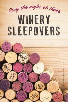 a pile of wine corks sitting on top of a wooden table next to a sign that says, enjoy the night at home winery sleepovers