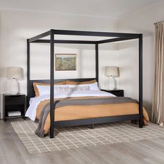 a bedroom with a four poster bed and two nightstands