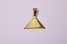 "Egyptian Handmade Egypt Pharaoh Pyramid 18K Yellow Gold Pendant 1.4 Gr Weight Approximate : 1.4 Gr Height : 0.59\" = 15 mm Width : 0.78\" = 20 mm ✔ IT IS Tested & SIGNED WITH THE EGYPTIAN Gold Government HALLMARK FOR 18K GOLD to Ensure Authenticity. ✔ Lovely gift idea ABSOLUTELY GORGEOUS, LOOKS FABULOUS ON. ✔ 100% Egyptian handmade. ✔ Condition: A brand-new, exactly as on the photos. ★ GIFTS ✔ All items are packaged in a paper jewelry gift box, ready for gifting. ✔ If you are sending a gift Sterling Silver Pyramid Jewelry As Gift, Pharaoh Jewelry, Egypt Pharaoh, Ancient Egyptian Necklace, Pyramid Bracelet, Egyptian Gold, Pyramid Necklace, Paper Jewelry, Yellow Gold Pendants