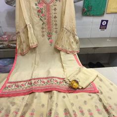 Tunic Top With Long Skirt With Thread Embroidery. This Is Semi Stitched So Can Be Stitched To Size. Spring Embroidered Silk Sharara, Semi-stitched Embroidered Georgette Dress, Spring Silk Sets With Embroidered Border, Spring Off White Sets With Embroidered Border, Off White Embroidered Georgette Dress, Summer Sharara With Embroidered Border, Fitted Georgette Sharara With Embroidered Border, Summer Festive Sharara With Embroidered Border, Elegant Sharara With Multicolor Embroidery