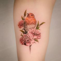 a small bird sitting on top of pink flowers