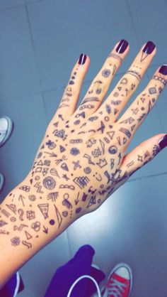 a person's hand with tattoos on it