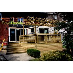 a wooden deck with trellis and steps