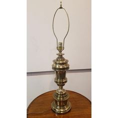 an antique brass lamp on a wooden table