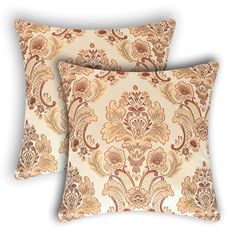 two decorative pillows with gold and red floral designs on the front, one has a white background