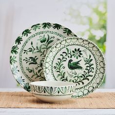 a green and white dinner set on a table