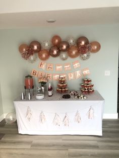 a table topped with lots of desserts and balloons