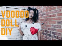 a woman standing in front of a brick wall with the words voodoo doll diy