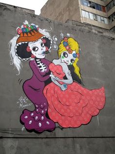 a large mural on the side of a building depicting two women in dresses and hats