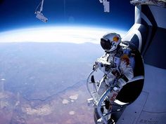 an astronaut is in the air above earth