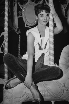 a woman sitting on top of a merry go round