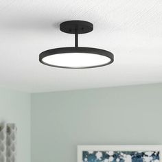 an overhead light fixture in a bedroom